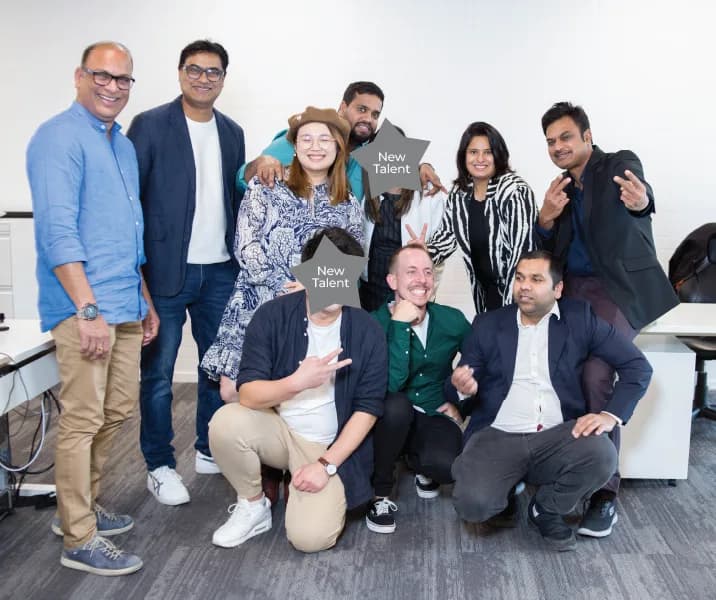 The Fivestar team gathered around a laptop in the studio